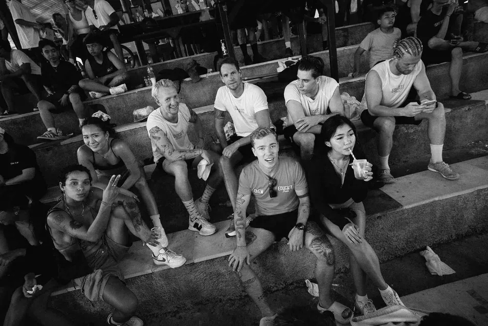 Friends and supporters watching from the bleachers, courtside